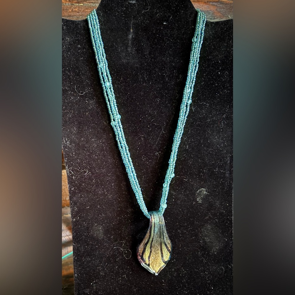 Multi strand, glass bead necklace with blown glass, large pendant